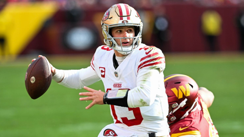 LANDOVER, MARYLAND - DECEMBER 31: Brock Purdy #13 of the San Francisco 49ers looks to pass under pressure during the second quarter of a game against the Washington Commanders at FedExField on December 31, 2023 in Landover, Maryland. (Photo by Greg Fiume/Getty Images)