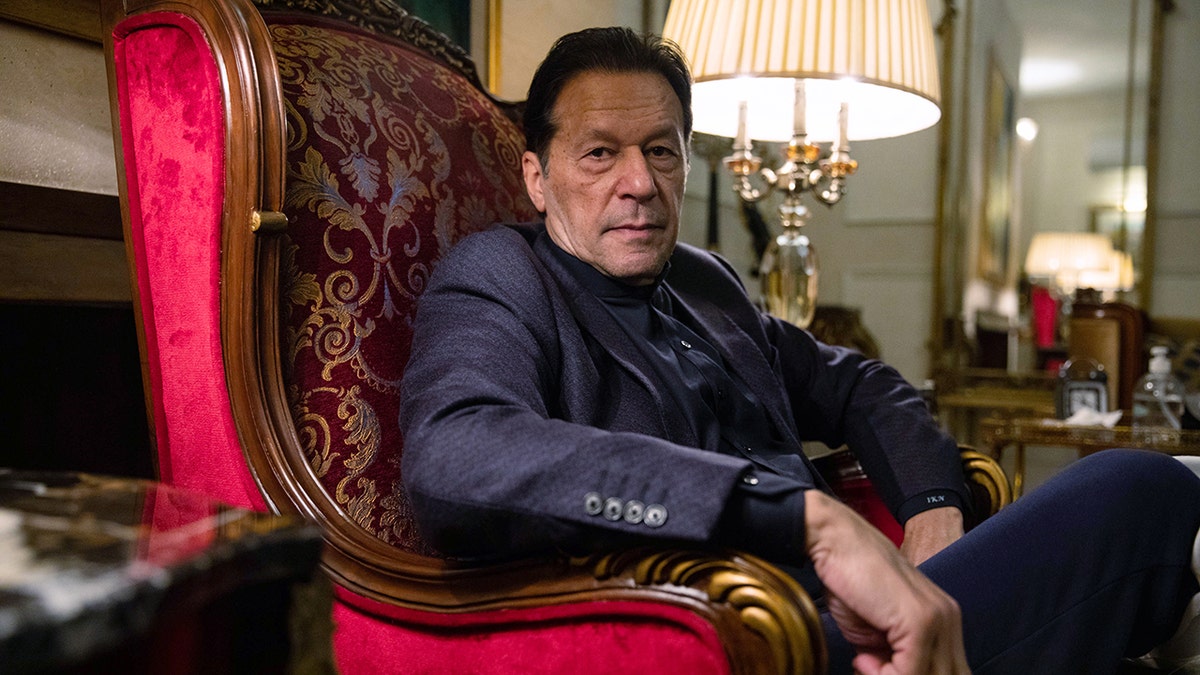 Khan sitting in a chair