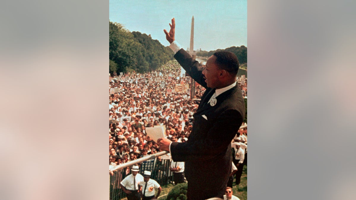 Martin Luther King Jr. waving to crowd