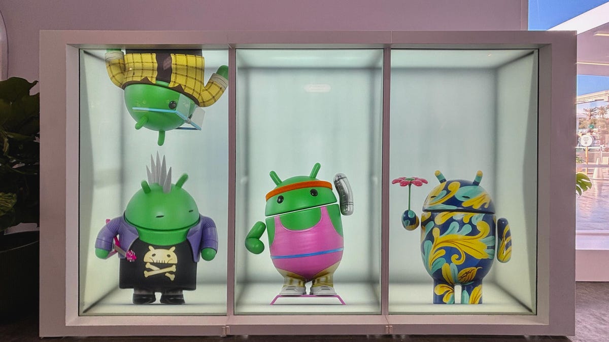 Four statues of Android mascots being playful