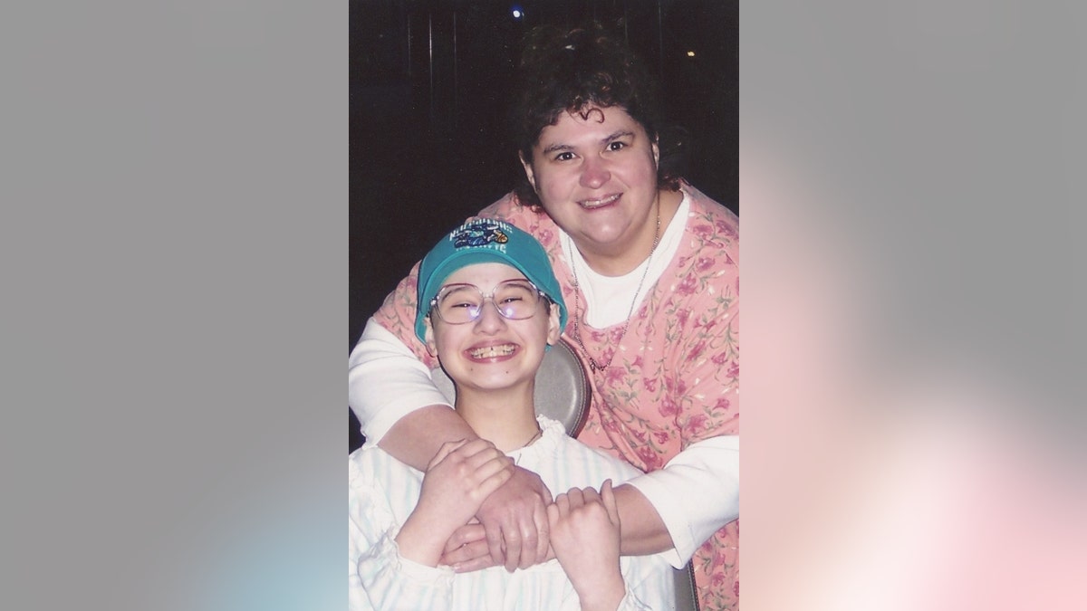 Gypsy Blanchard (left) in a wheelchair and Dee Dee Blanchard (right) with her arms around Gypsy