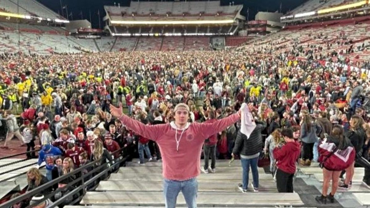 Nicholas Donofrio poses in from of the USC football stadium
