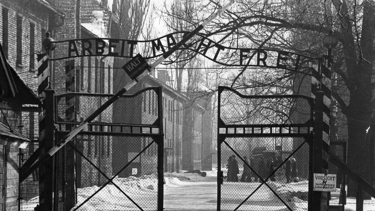 Gates of Auschwitz in black and white photo