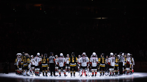 PITTSBURGH, PENNSYLVANIA - OCTOBER 30: Pittsburgh Penguins and Anaheim Ducks players stand for a moment of silence following the death of former Penguins player Adam Johnson, prior to their game at PPG PAINTS Arena on October 30, 2023 in Pittsburgh, Pennsylvania. (Photo by Harrison Barden/Getty Images)