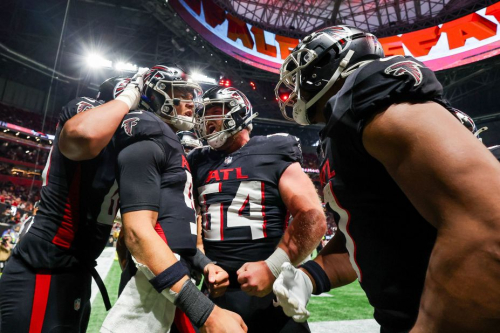 Atlanta Falcons quarterback Desmond Ridder celebrates with teammates after scoring a touchdown. The Falcons lost 29-25 to the Tampa Bay Buccaneers.