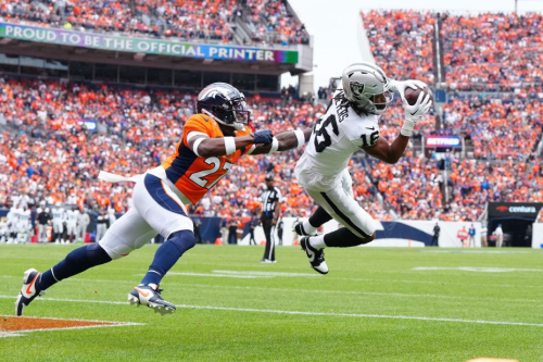 Las Vegas Raiders WR Jakobi Meyers pulls in a touchdown past Denver Broncos CB Damarri Mathis in the first quarter at Empower Field at Mile High. The score would be important as the Raiders edged the home side, 17-16.
