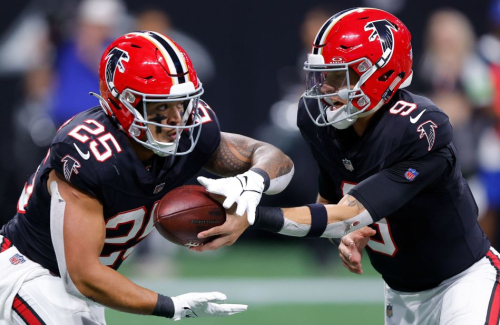 Desmond Ridder of the Atlanta Falcons hands the ball off to Tyler Allgeier during the Falcons' 24-15 victory over the New Orleans Saints.