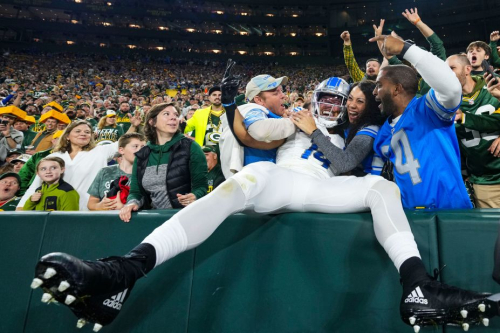 Amon-Ra St. Brown of the Detroit Lions celebrates with fans during his team's 34-20 victory over the Green Bay Packers at Lambeau Field on September 28.
