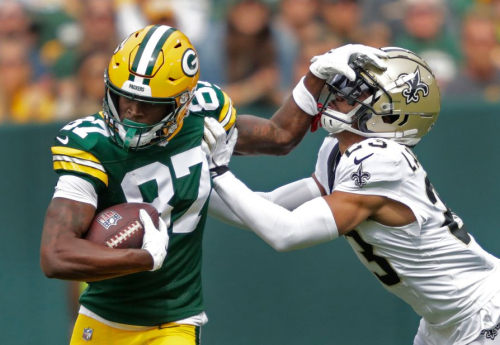 Green Bay Packers wide receiver Romeo Doubs fends off New Orleans Saints cornerback Isaac Yiadom during the first half at Lambeau Field. The Packers edged out a 18-17 win. 