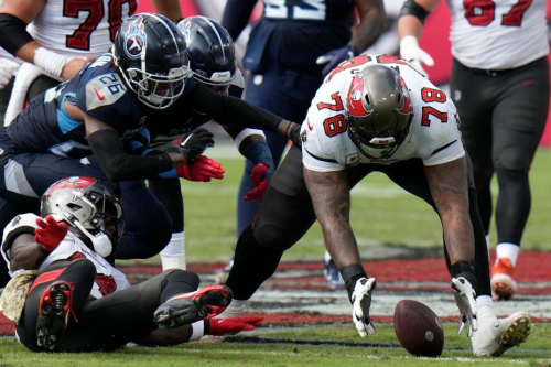 Tampa Bay Buccaneers offensive tackle Tristan Wirfs recovers a fumble. 