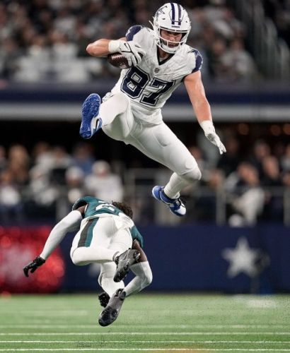 Dallas Cowboys tight end Jake Ferguson leaps over Philadelphia Eagles cornerback Kelee Ringo during the Cowboys' 33-13 victory. With the win, the Cowboys extended their home winning-streak to 15 games.