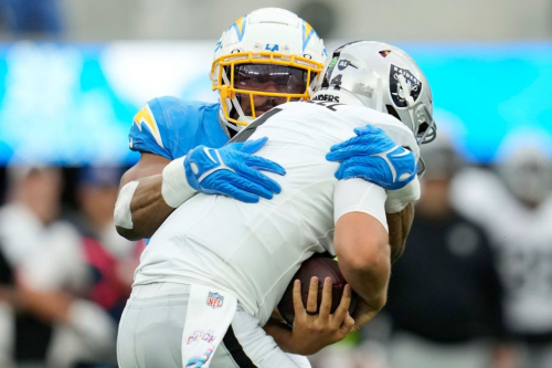 Los Angeles Chargers linebacker Khalil Mack sacks Las Vegas Raiders quarterback Aidan O'Connell during the Chargers' 24-17 victory on October 1. Mack recorded six sacks, becoming the fifth player in NFL history to do so in a single game.
