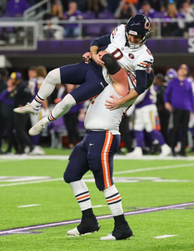 Chicago Bears offensive lineman Lucas Patrick lifts placekicker Cairo Santos after Santos kicked the game winning field goal against the Minnesota Vikings on Monday, November 27. The Bears defeated the Vikings 12-10.