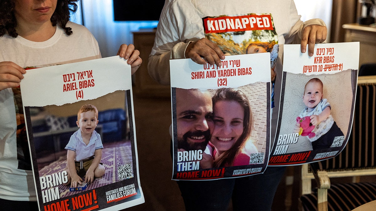 Ofri Bibas Levy holds posters depicting her missing brother Yarden who was kidnapped by Hamas along with his wife and two children