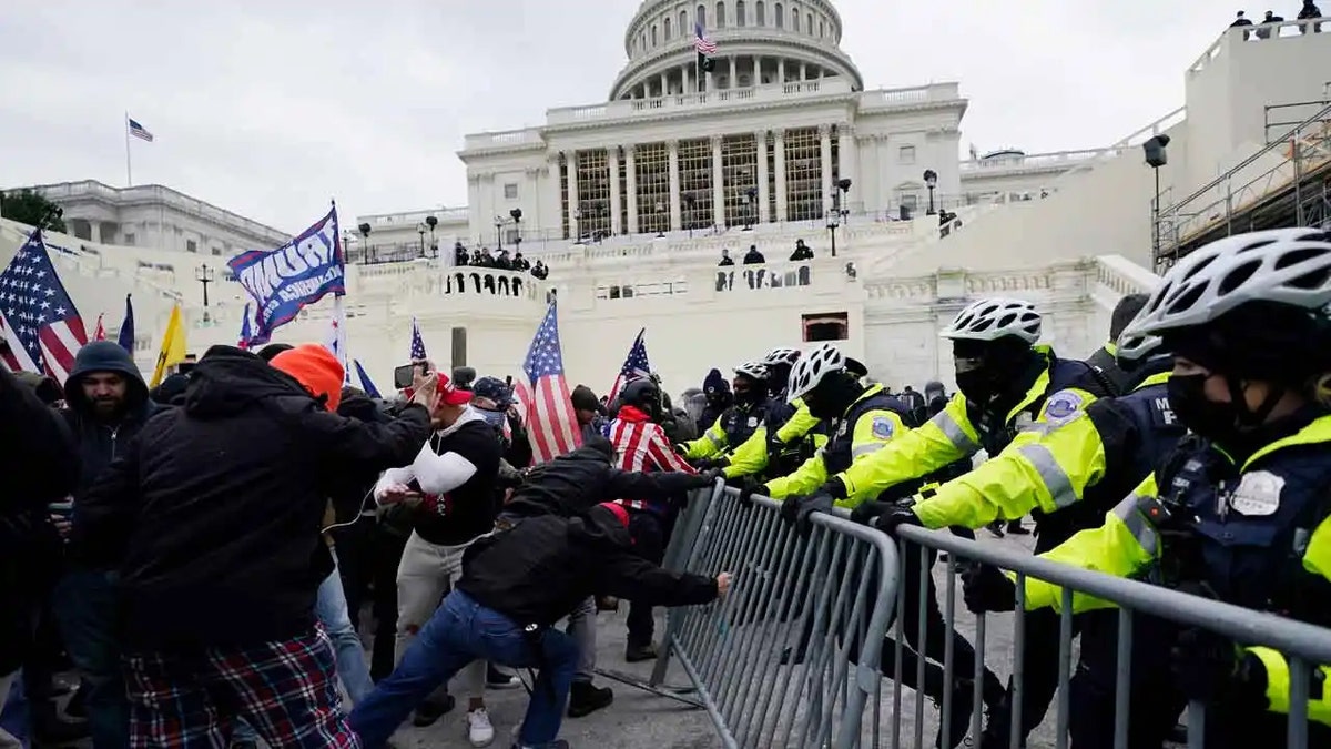 Police try to hold back protesters during the January 6 riot at the US Capitol in 2021.