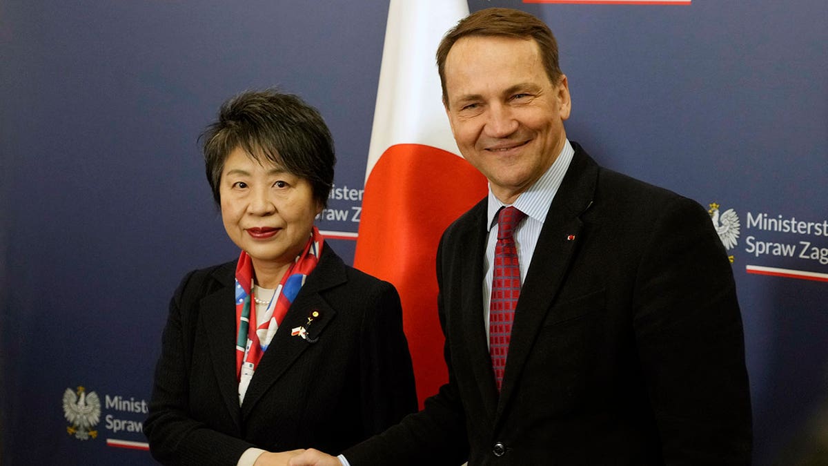 Yoko Kamikawa shakes hands