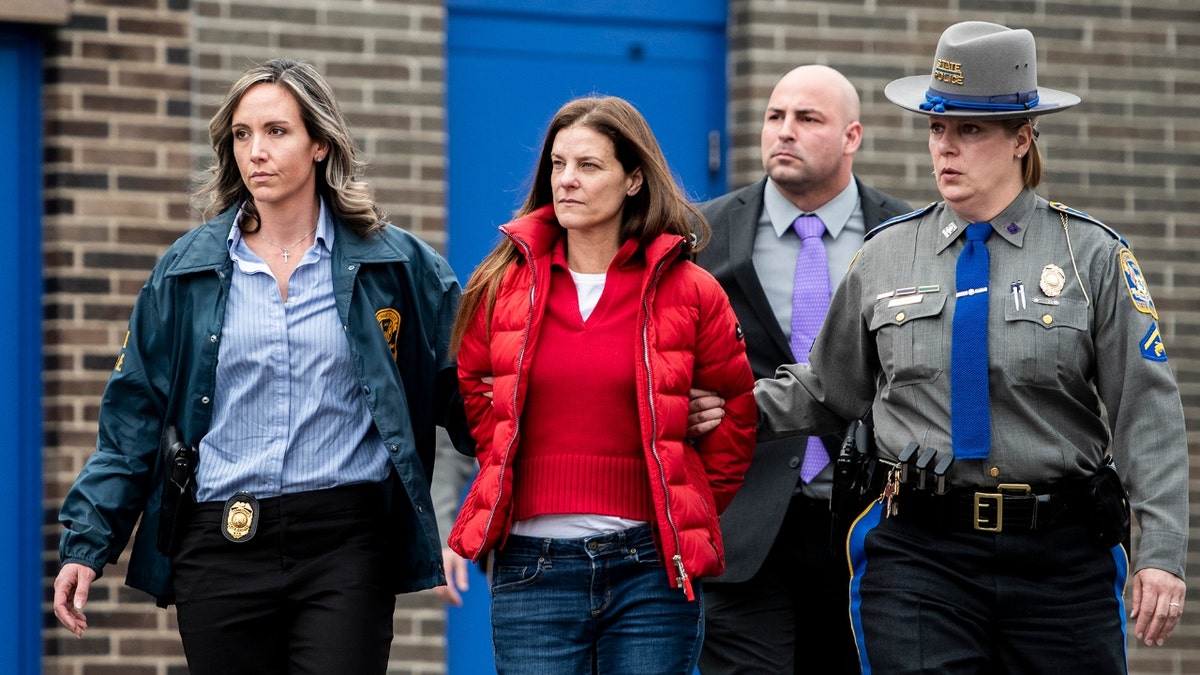 Michelle Troconis is escorted out of the Troop G State Police station before being placed into a cruiser Tuesday afternoon, Jan. 7, 2020. Troconis was arrested and charged with conspiracy of murder charges in correlation with Jennifer Farber Dulos' missing persons case.