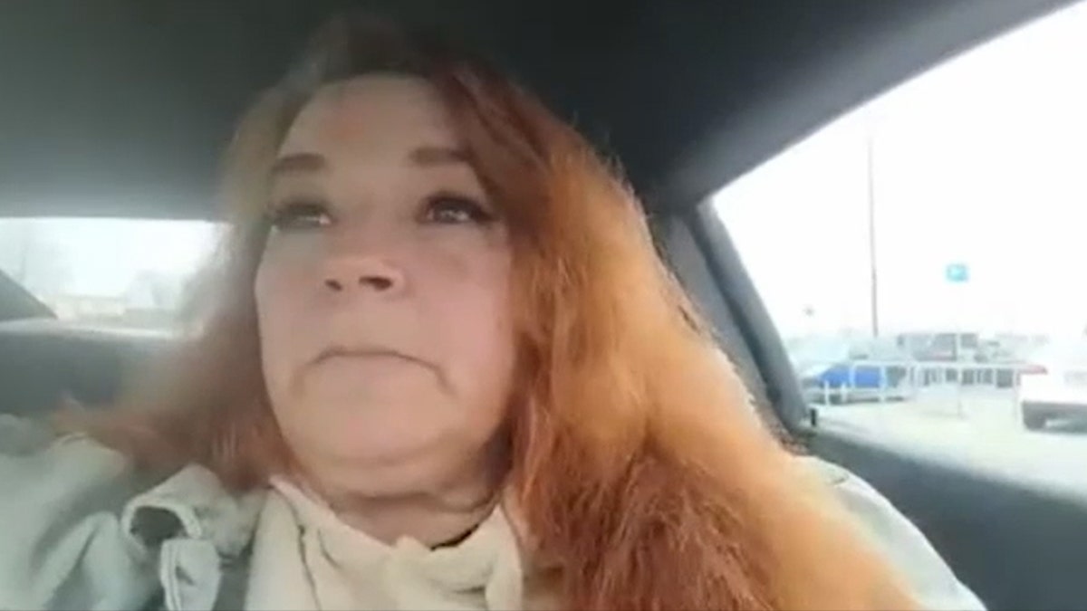 David Harrington's mother, in car, has long red hair
