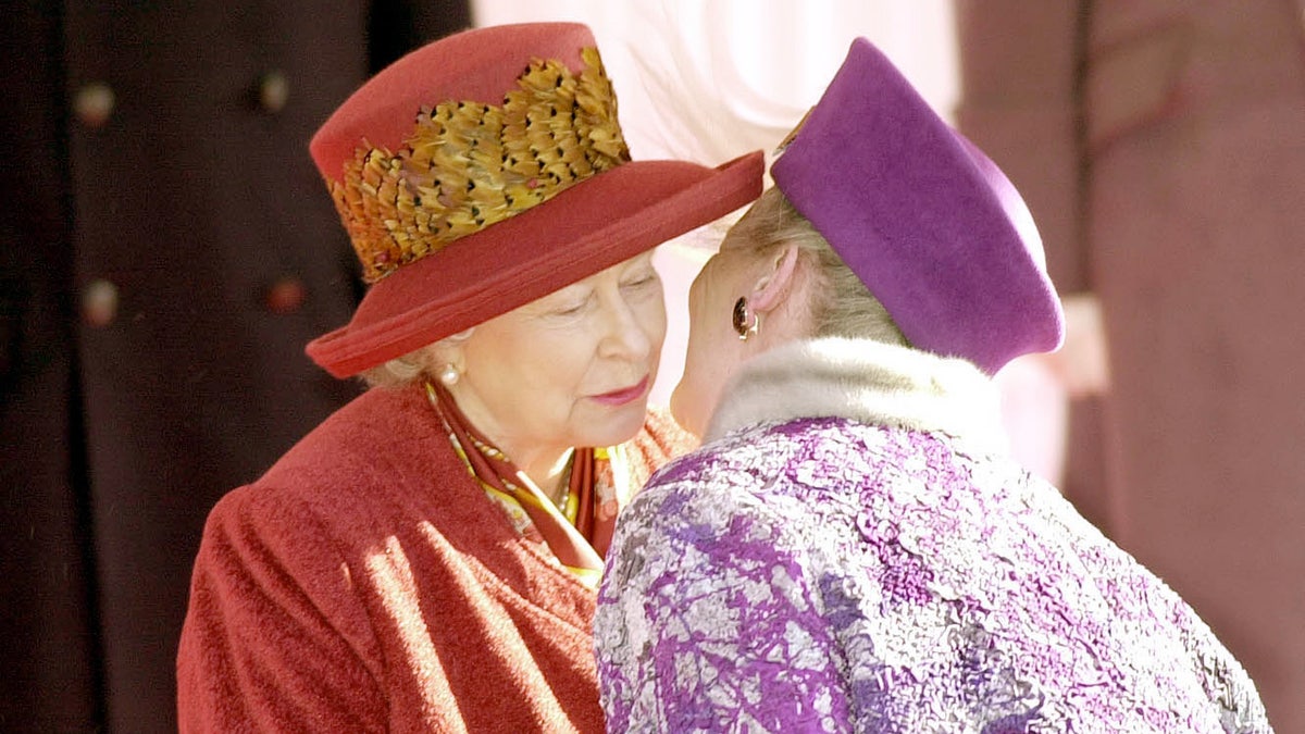 Queen Elizabeth getting kissed on the cheek by Queen Margrethe