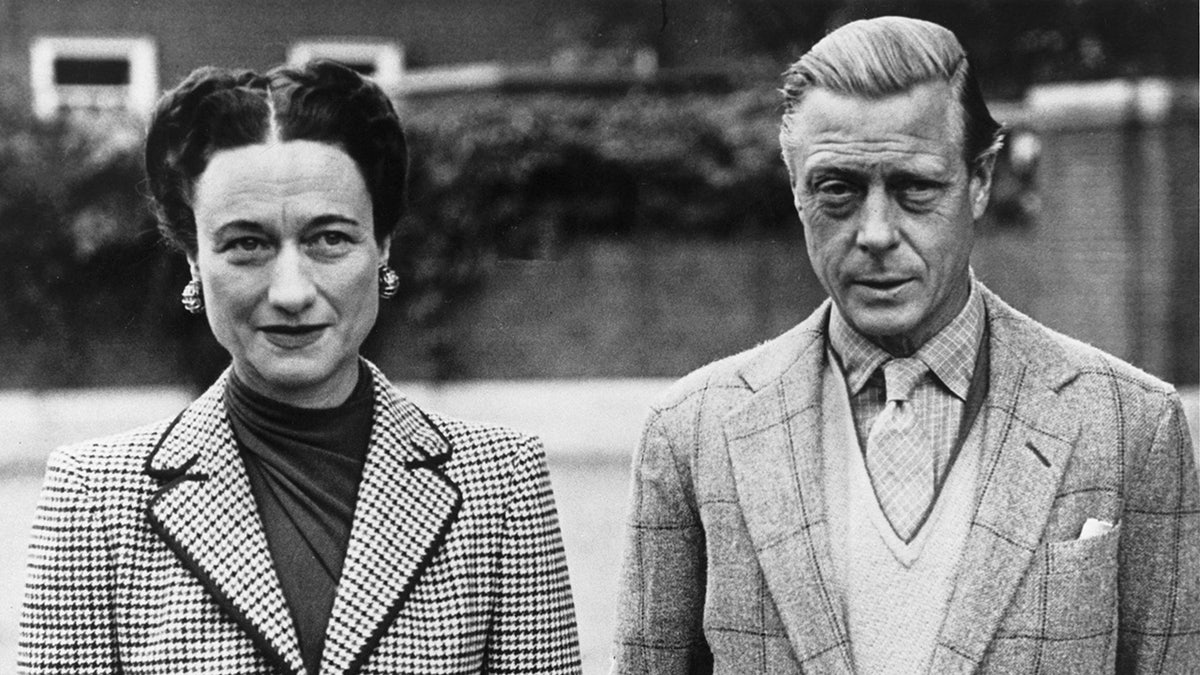 The Duke and Duchess of Windsor standing next to each other and looking serious