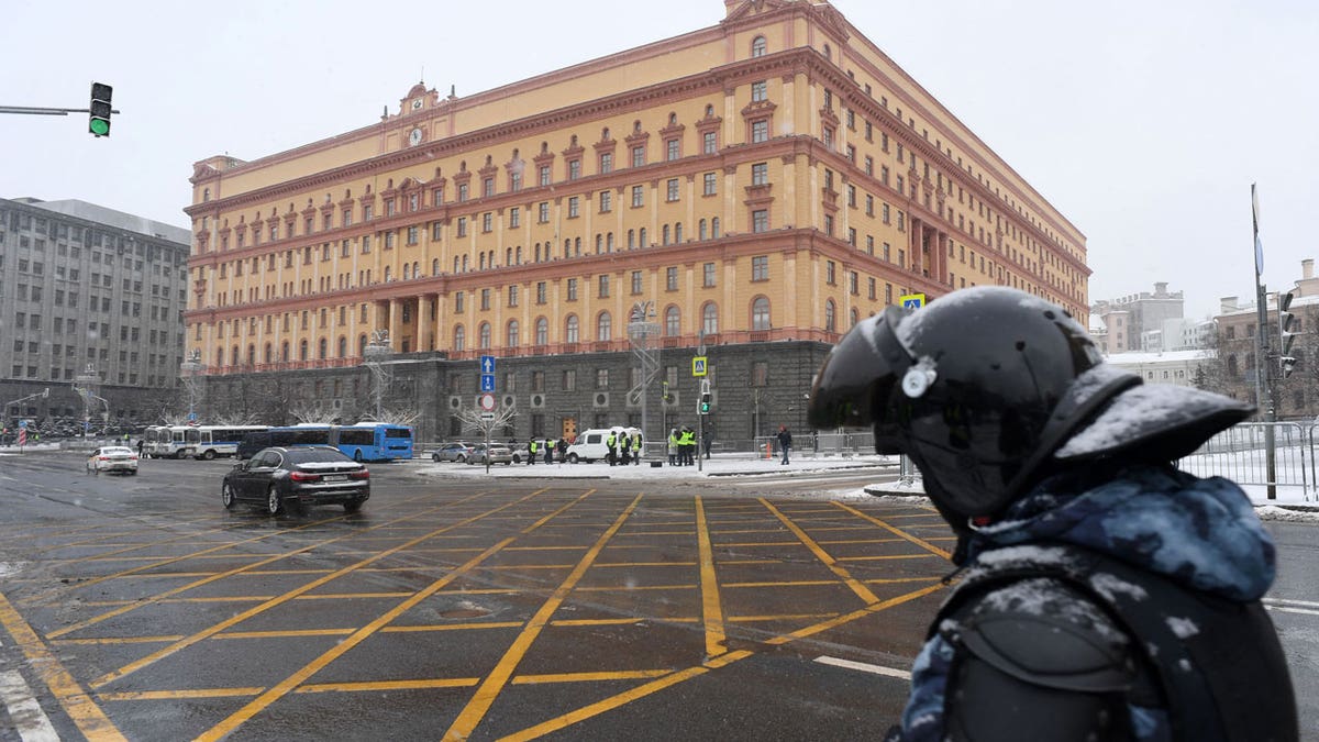 A law enforcement officer stands guard near the headquarters of Russia's Federal Security Service