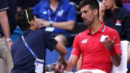 PERTH, AUSTRALIA - JANUARY 03: Novak Djokovic of Team Serbia receives treatment to his right arm during his singles match against Alex de Minaur of Team Australia during day six of the 2024 United Cup at RAC Arena on January 03, 2024 in Perth, Australia. (Photo by Paul Kane/Getty Images)