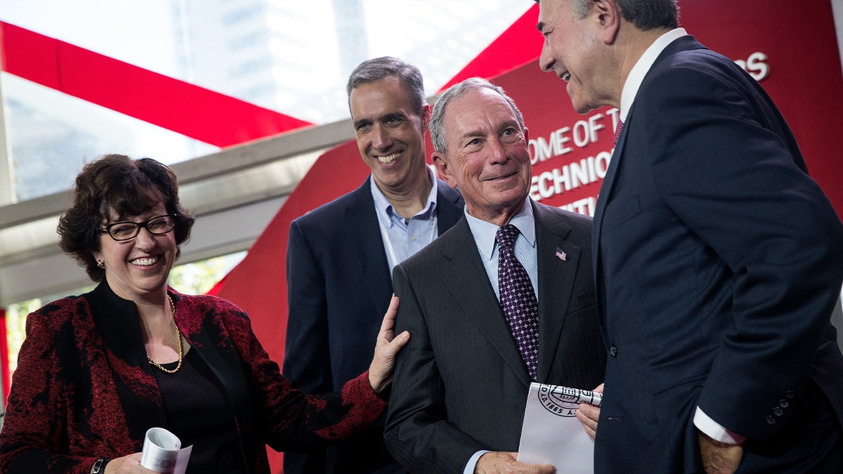 Martha Pollack of Cornell, left, with Michael Bloomberg second from right