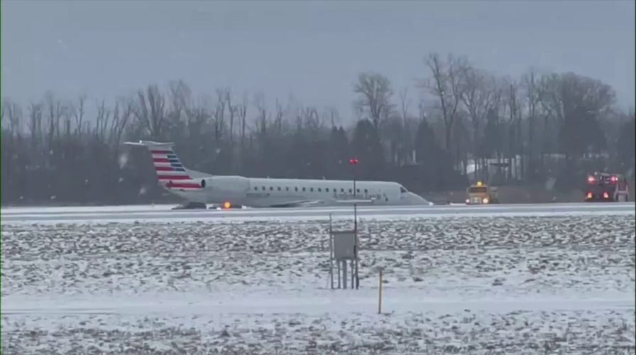 American Airlines plane slides of taxiway at New York airport amid snowy weather
