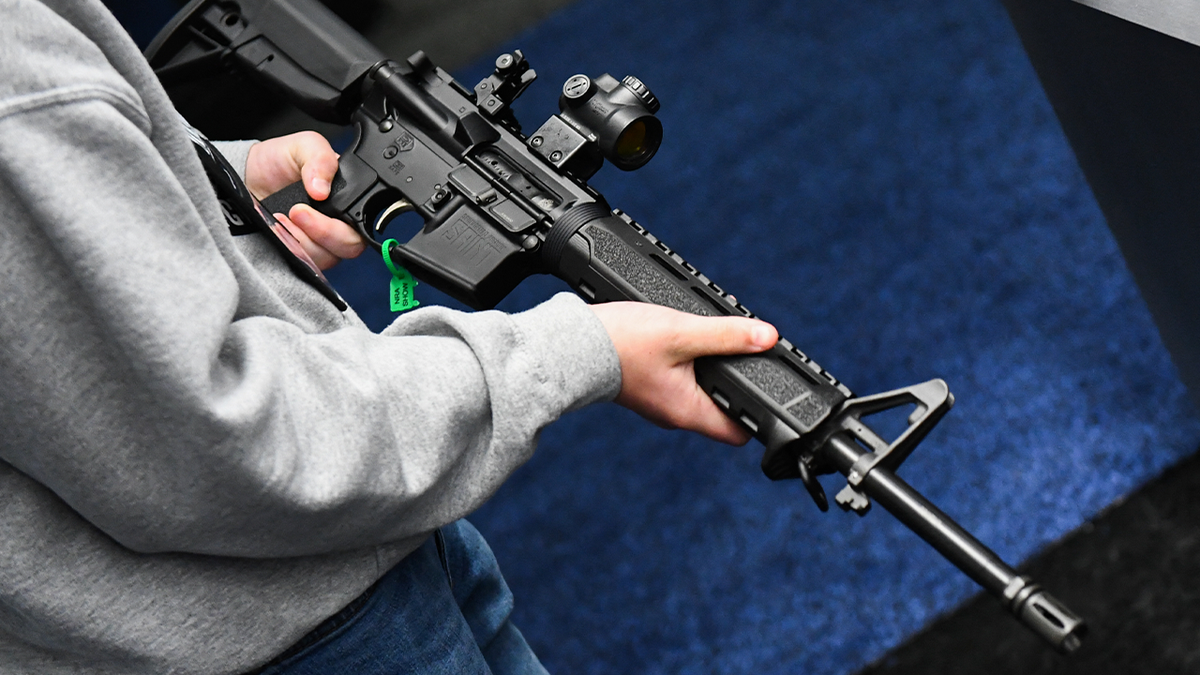 Person holding AR-15 rifle