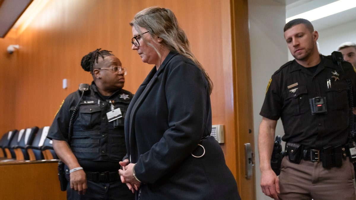 Jennifer Crumbley, center, enters the Oakland County courtroom of Judge Cheryl Matthews on Monday, Jan. 29, 2024, in Pontiac, Mich. 