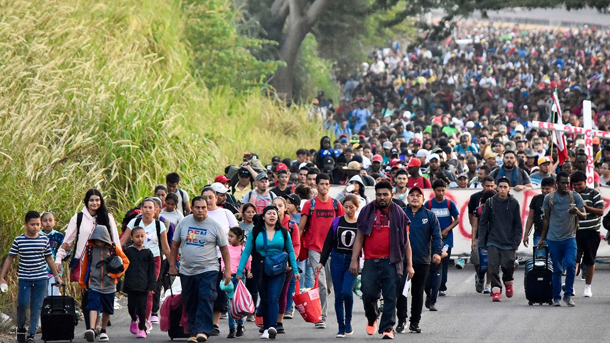 A large group of migrants walking