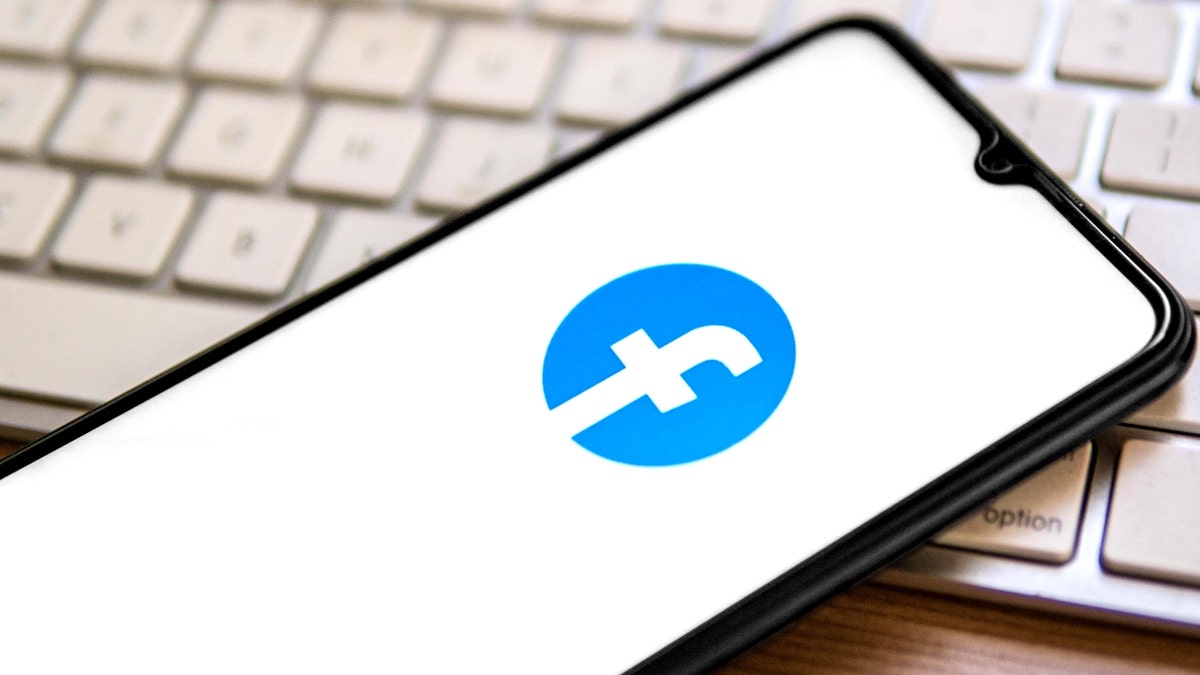 A Facebook logo on a phone