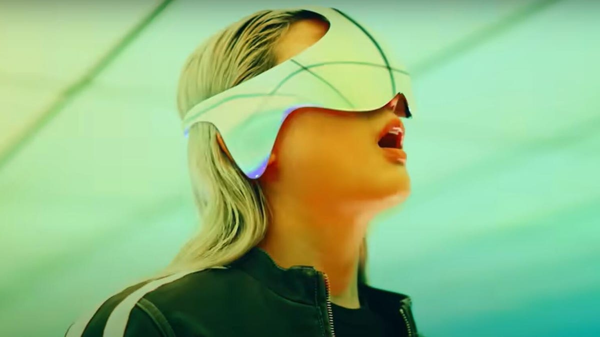 woman wearing unmarked chrome VR headset.