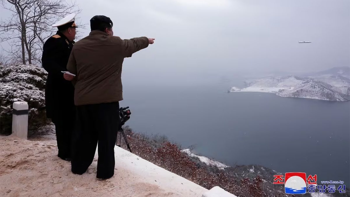 Kim Jong Un points at missile