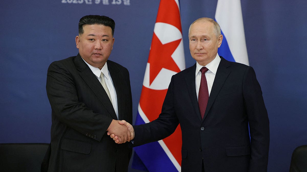 Kim Jong Un, Putin shaking hands