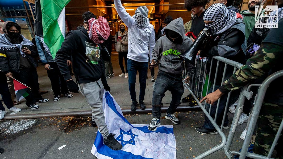 Protester trample on Israel flag in street
