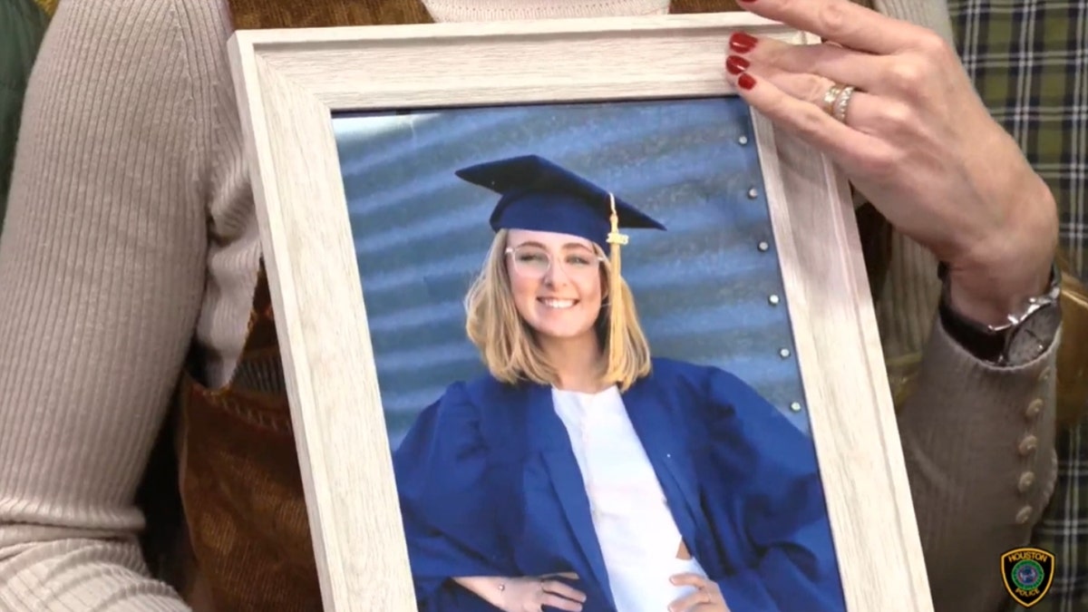 Krista Wilson holds a photograph of her daughter, Louise Wilson