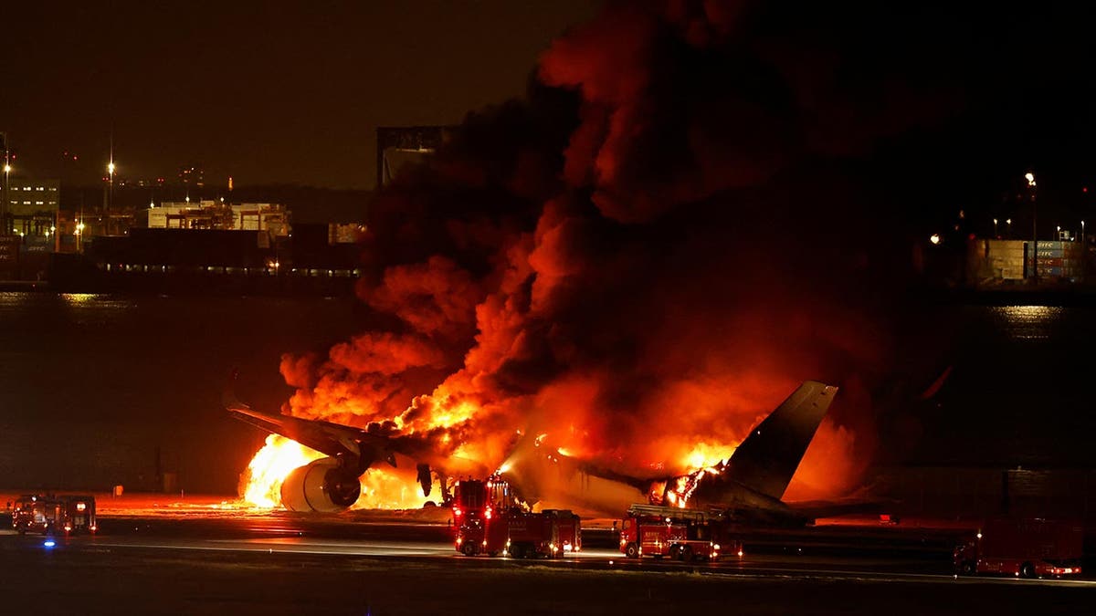 Plane on fire on the tarmac in Tokyo