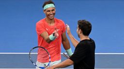 Spain's Rafael Nadal (L) shakes hands with partner Marc Lopez after losing their men's doubles match against Australia's Max Purcell and Jordan Thompson at the Brisbane International tennis tournament in Brisbane on December 31, 2023.