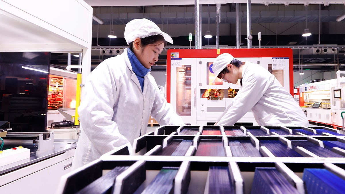 A worker is producing photovoltaic modules for export at a workshop of a new energy company in the Sihong Economic Development Zone in Suqian, Jiangsu Province, China, on January 23, 2024. (Photo by Costfoto/NurPhoto via Getty Images)