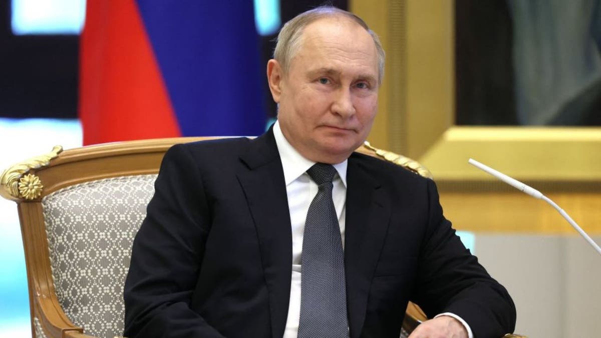 Russian President Vladimir Putin sitting