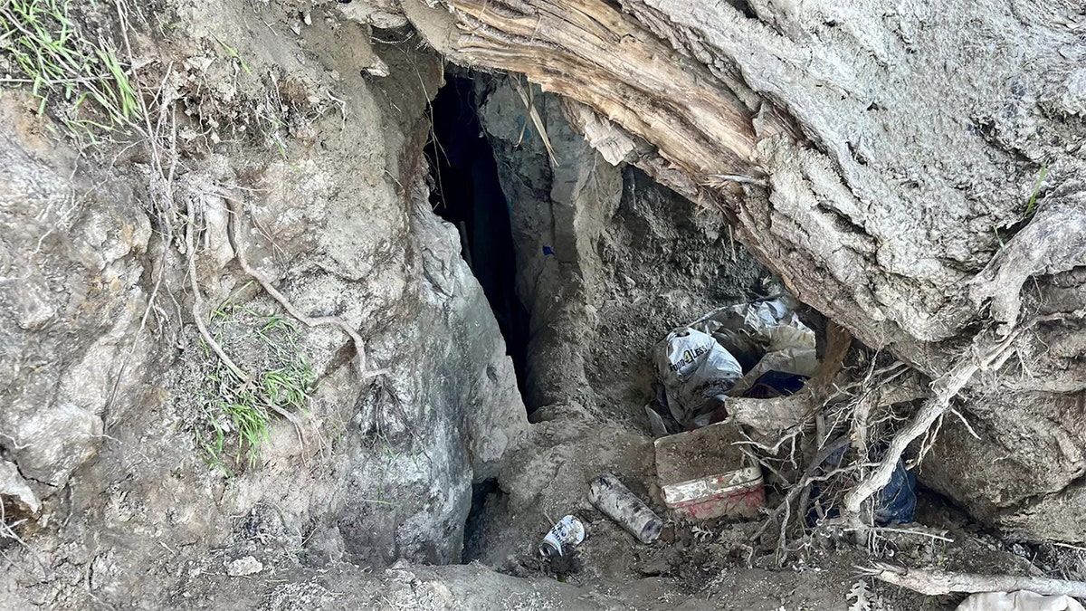 A cave entrance where homeless people set up residences