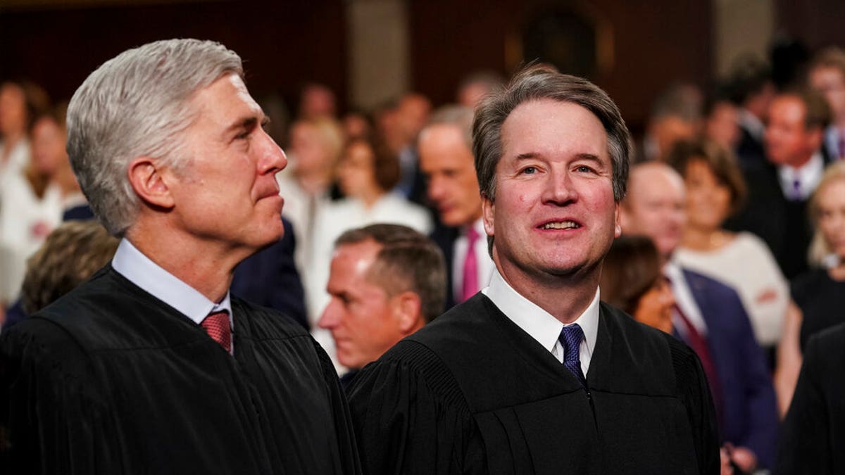 Justice Gorsuch and Justice Kavanaugh stand next to each other