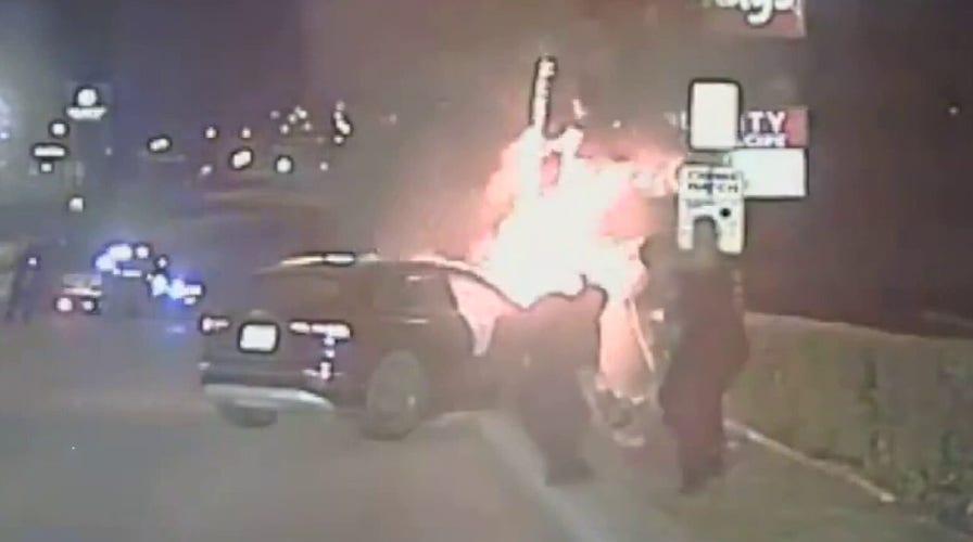 Texas police rescue unconscious man from burning car after crash