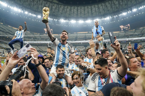 Argentina forward Lionel Messi (10) holds aloft the World Cup trophy after defeating France to win the final match of the FIFA World Cup 2022 between Argentina and France at Lusail Stadium in Lusail, Qatar on December 18, 2022.