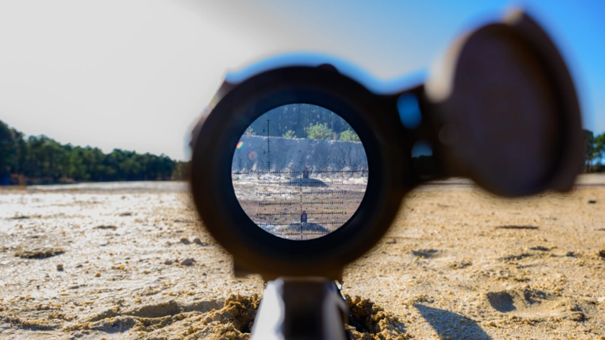 looking through sniper rifle scope downrange