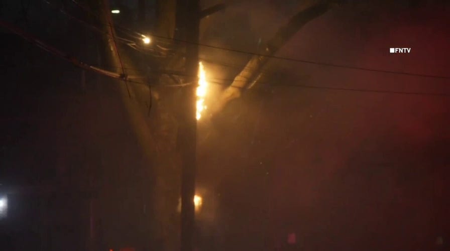 Power poles and wires ablaze during storm in NYC neighborhood