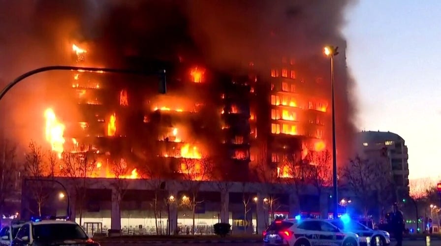 At least 4 dead, 14 missing as massive fire tears through residential building
