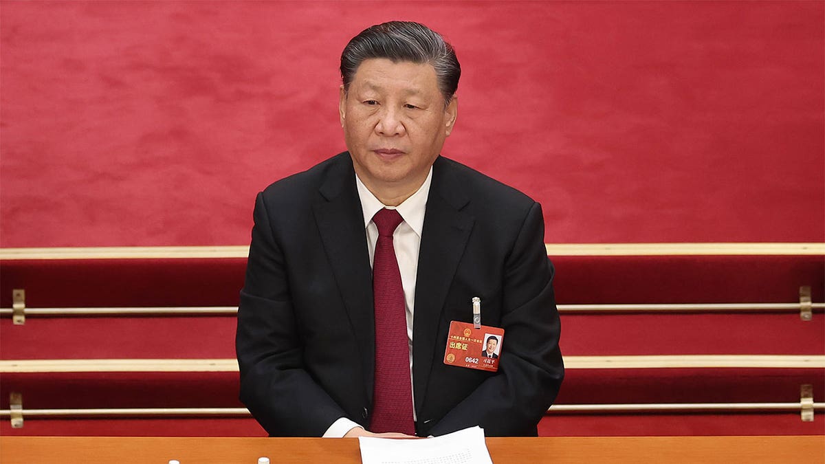 Chinese President Xi Jinping sitting at a session.