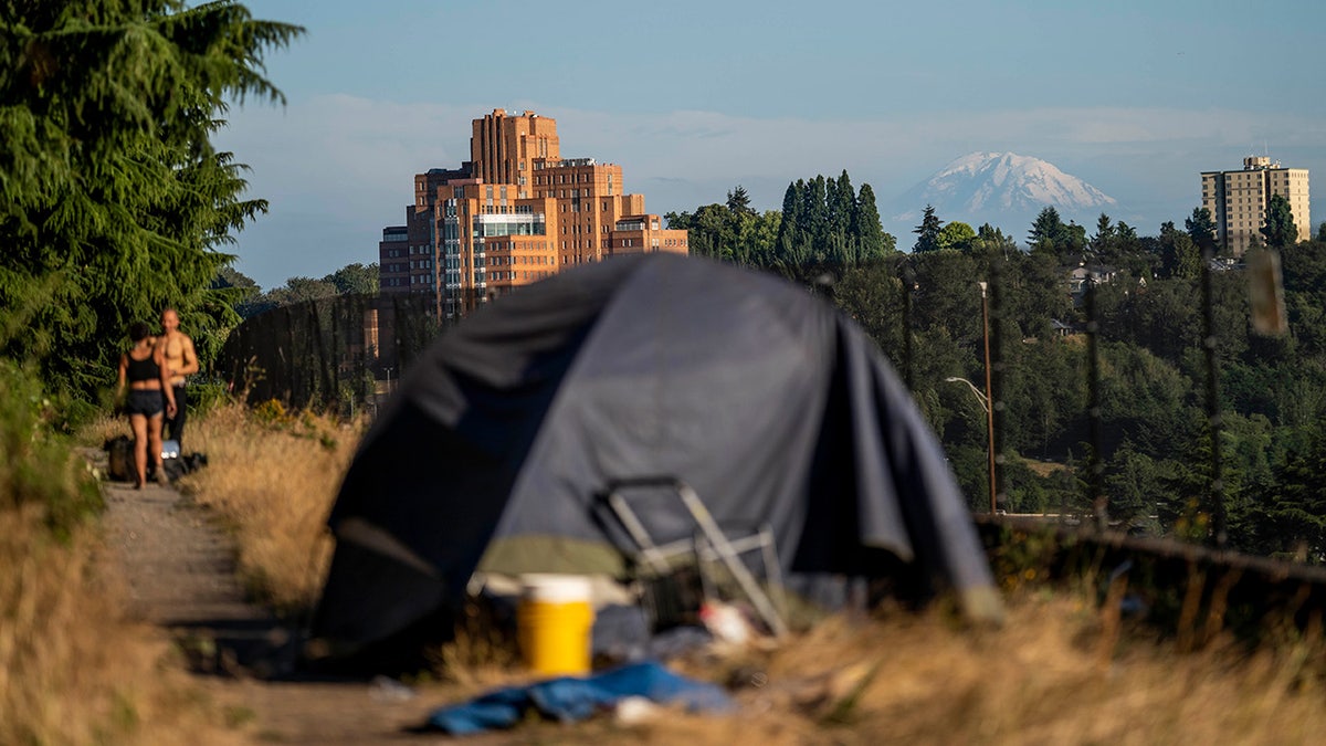 Tent sits alongside I-5 near Seattle with city in background